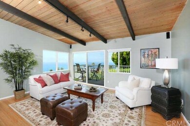 Light & bright living room with ocean view deck.