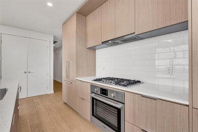 Kitchen featuring modern cabinets, light brown ca