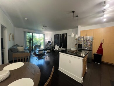Kitchen with hanging light fixtures, a kitchen isl