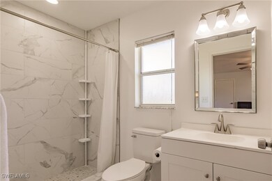 Bathroom featuring a shower with curtain, vanity,