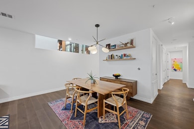 Dining space with dark wood finished floors