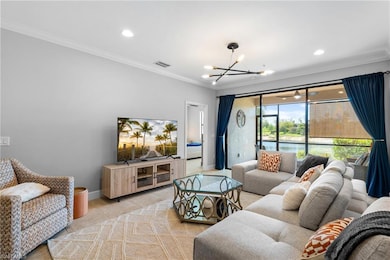 Living area featuring ornamental molding, recessed