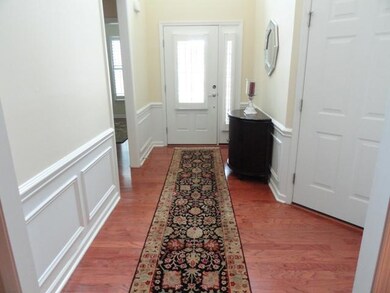 Grand entry with high grade engineered wood flooring, wainscoating and attractive crown molding.