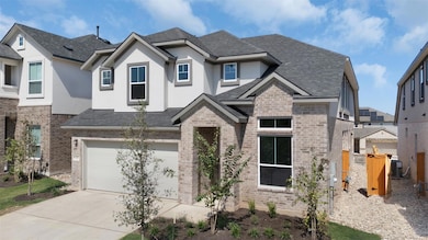 View of front of property with brick siding, stucco siding, concrete driveway, and roof with shingles