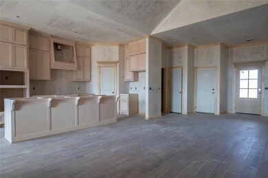 Kitchen with light brown cabinetry, a kitchen isla