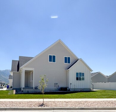 Back of property with board and batten siding and roof with shingles