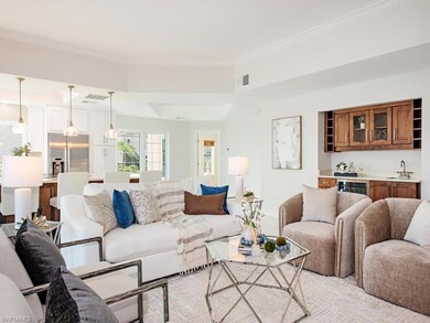 Living room featuring ornamental molding and sink