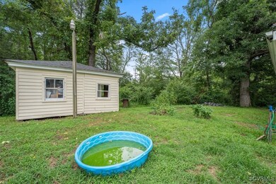 View of grassy yard with an outdoor structure and