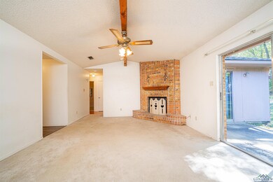 Unfurnished living room with lofted ceiling, a bri