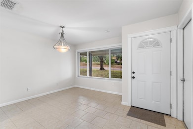 Entrance foyer featuring light tile patterned flo
