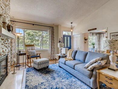 Bright living room w/ wood floor & gas fireplace w