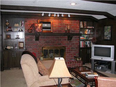 Main floor family room features beamed ceiling, cu