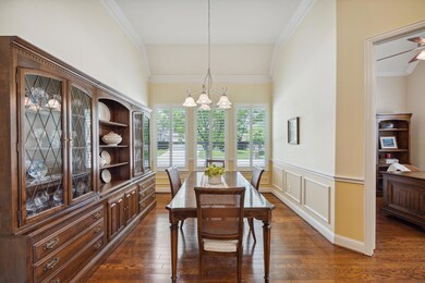 Dining area with ceiling fan with notable chandeli