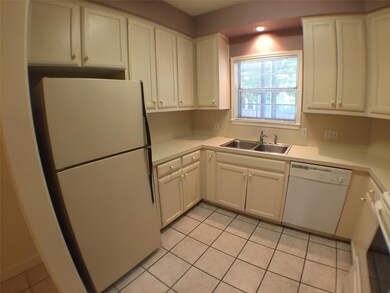 Kitchen with light countertops, light tile patter
