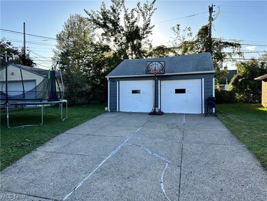 Garage with a trampoline and a lawn