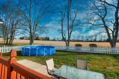 Area off deck with patio, pickett fence and above ground pool with updated sand filter pump.