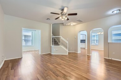 Unfurnished room with arched walkways, visible ve