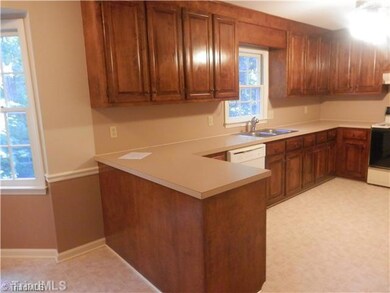 Kitchen. Bright kitchen with wood cabinets, fresh paint and view of back yard.