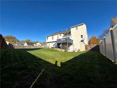 Back of property featuring a fenced backyard, stairway, and a deck