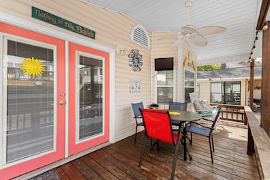 Wooden deck featuring a ceiling fan and outdoor dining area