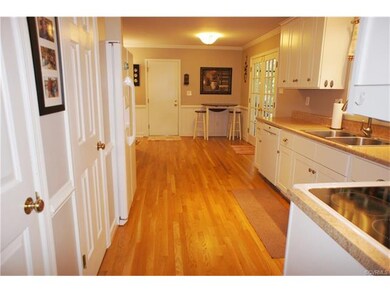 Beautiful white cabinets, hardwood floors and neut