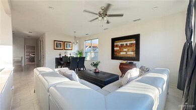 Living room with light tile patterned floors, a chandelier, recessed lighting, and ceiling fan