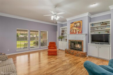 Living room featuring a fireplace, ceiling fan, li