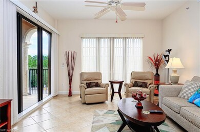 Living room with ceiling fan, light tile patterned