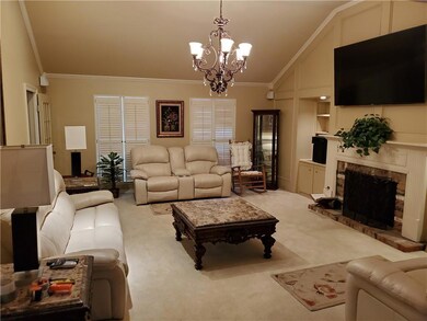 Living room features unique ceiling, gas log firep