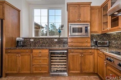 Pecan cabinetry, Wolf range, wine fridge, microwav