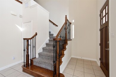 Tiled entryway featuring a high ceiling
