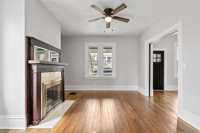 spacious living room separated by original wood po