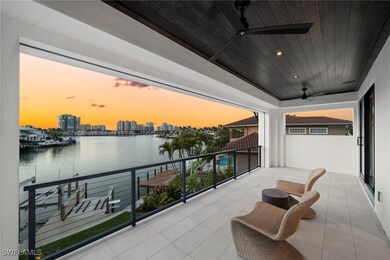 Balcony at dusk with a water view and ceiling fan