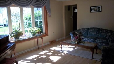 Living room featuring refinished hardwood flooring