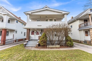 View of front of home featuring a front yard, a balcony, and a porch