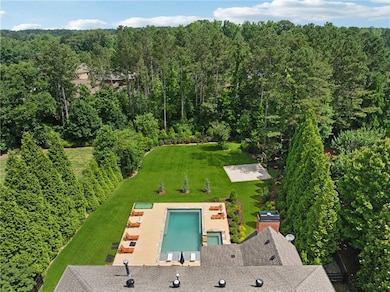 Aerial view of property and surrounding area featuring a heavily wooded area