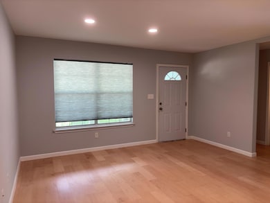 Foyer entrance with light wood-style floors and r