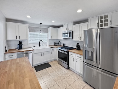 Beautiful kitchen with crisp white cabinetry and b