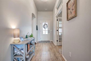 Entrance foyer with hardwood / wood-style floors