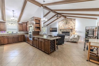 The kitchen and family rooms feature vaulted ceilings with stunning wood beams.