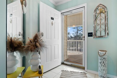 Doorway featuring baseboards, light tile patterned