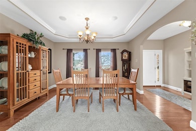 Elegant dining room features arched entry accents,