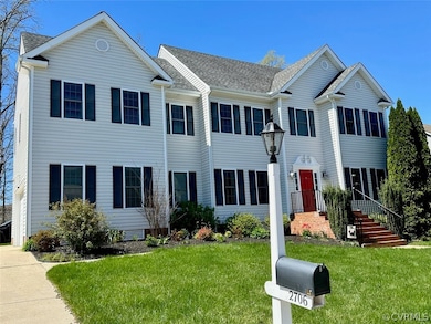 Colonial house featuring a front yard
