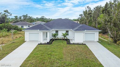 Ranch-style house featuring a garage, a front lawn