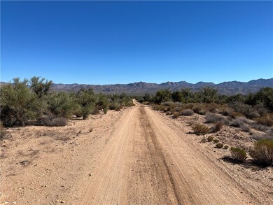 View of dirt / gravel road with a mountain view