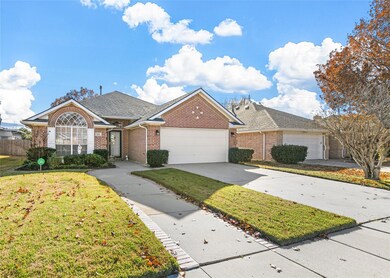 Single story home featuring a front yard and a gar