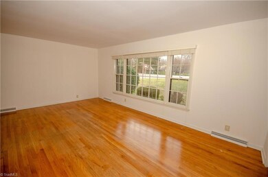 Living room has picture window and beautiful hard woods. All windows have new custom blinds.