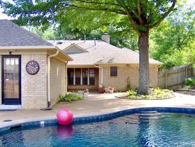 Extensive pool decking, covered patio and entry to