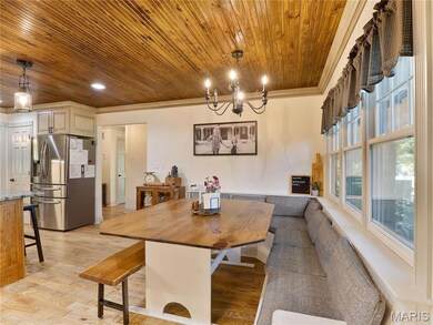 Dining room with wood ceiling, ornamental molding, light wood-style flooring, a chandelier, and recessed lighting