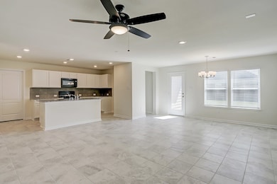 Family room opens to kitchen. Notice all the natur